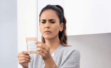 Woman Holding Material at Arm’s Length to Read