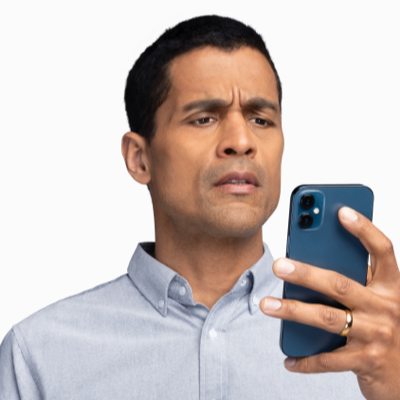 Man Holding a Phone and Squinting to Read